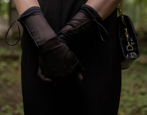 view of woman wearing sheer black gloves 